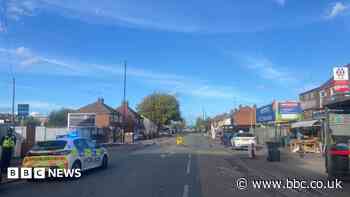 Road closed as police deal with rooftop incident