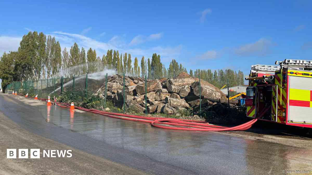 Crews tackling fire involving 'large timber pile'