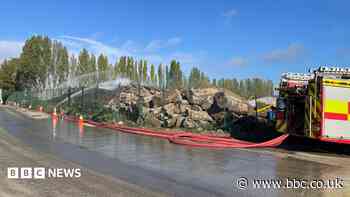 Crews tackling fire involving 'large timber pile'
