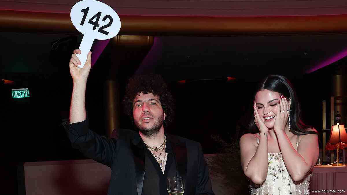Selena Gomez looks embarrassed by Benny Blanco at celebrity auction... after marking first wedding anniversary