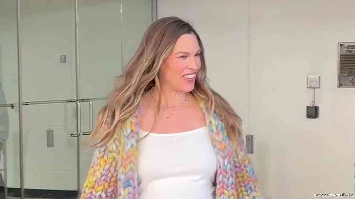 Pregnant Hilary Swank, 52, reveals her growing bump for the first time... hours after revealing baby joy