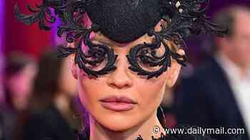 Rita Ora steals the show in a kooky black lace gown and a huge headpiece as she supports husband Taika Waititi and star Jenna Ortega at Klara And The Sun premiere