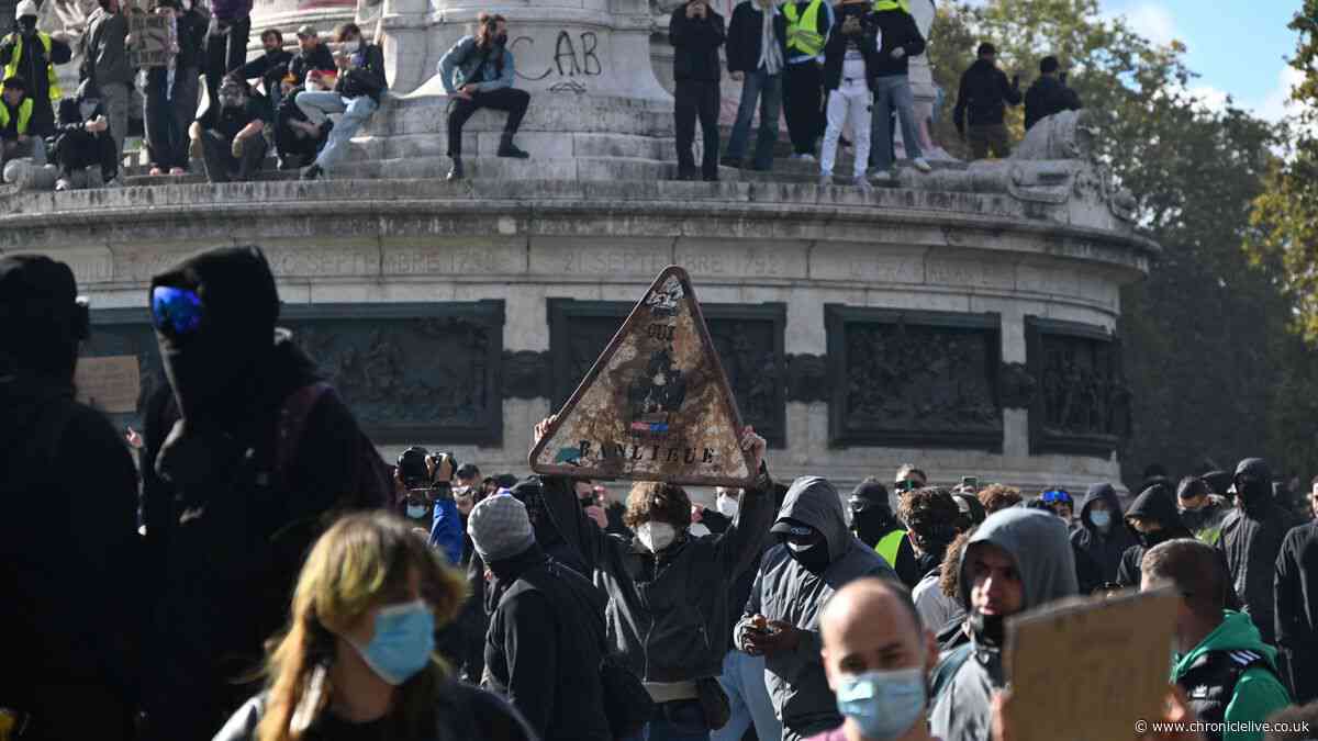 Rioters torch town halls during nationwide French protests as Macron issues stern warning