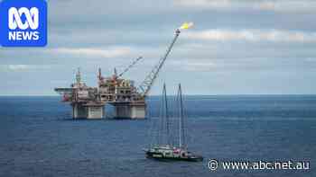 Two people in custody after protest at offshore Woodside gas platform
