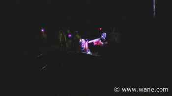 Car goes off US 24, lands upside down on railroad tracks