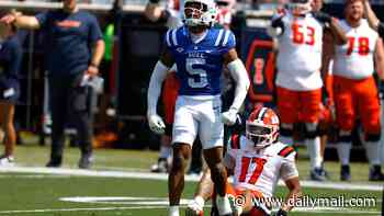 Duke football player who violently swiped at young female staffer was caught on camera lashing out at security guard a week earlier