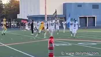 Shocking moment unpatriotic high school football player slams into rival carrying an American flag on the field