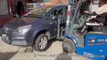 Fuming man in Stockport uses forklift to move car after driver parks in front of his shop