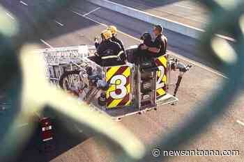 Chaos above the 55: woman rescued after climbing freeway sign in Santa Ana