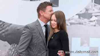 Jeremy Renner plants a sweet kiss on daughter Ava Berlin, 13, as they walk the red carpet at the Alice nella Città film festival in Rome - three years after his near-fatal snowplow accident