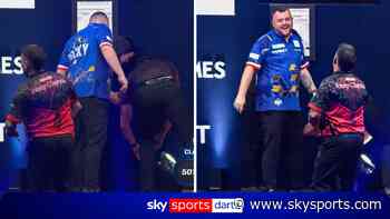 Players laugh as Rock LOSES his dart on stage during match