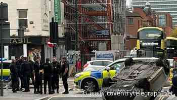 Car flipped onto roof after crash in Manchester city centre