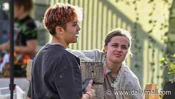 Angeline Jolie's daughter Vivienne, 18, gets sweet support of twin brother Knox as he helps her sell art at LA street fair