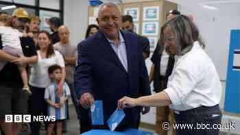 Political rivals, and their wives, vote in Israeli election
