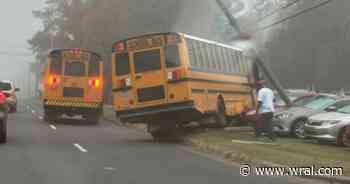 School bus crashes into utility pole at Durham car dealership