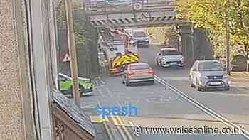 Neighbours look on in dismay as another lorry smashes into notorious bridge