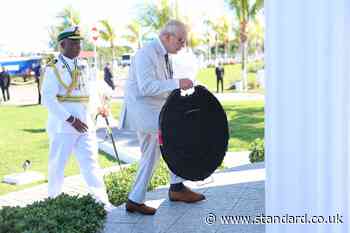 King honours fallen troops in solemn start to second day of Caribbean tour