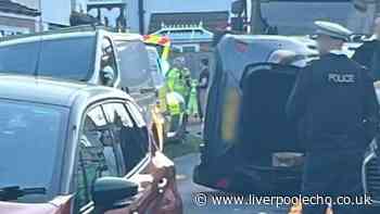 Woman taken to hospital after car flips onto its side in West Derby