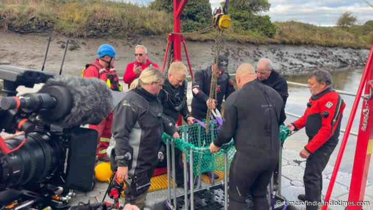 Diver searching the bottom of England’s River Wear has pulled a huge three legged iron cauldron